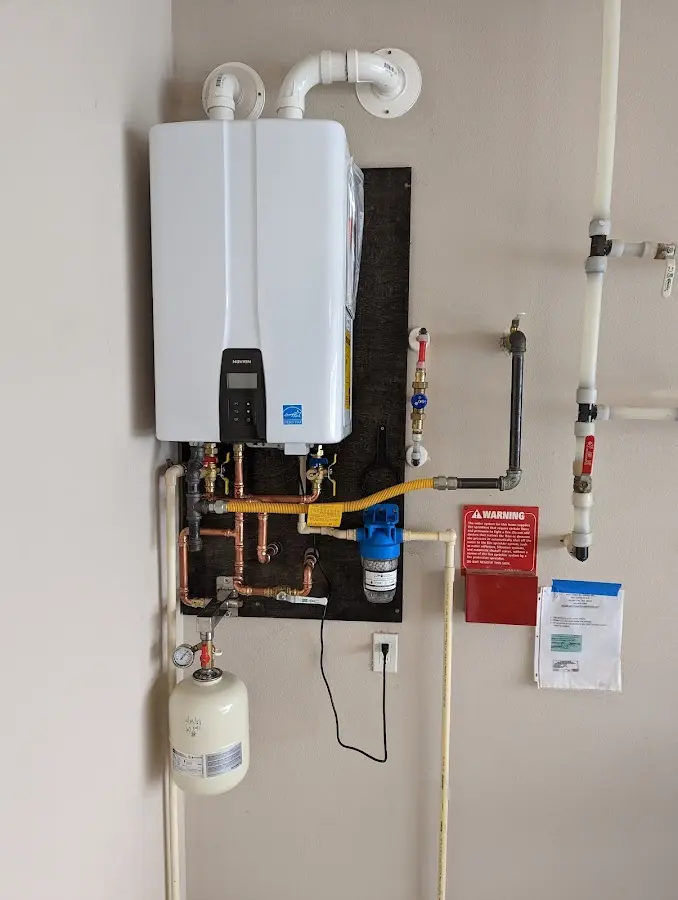 Professional plumber installing copper piping in a Myrtle Grove home